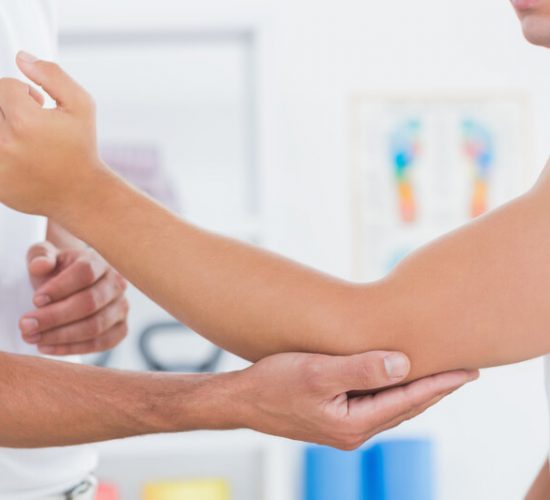 Doctor examining his patient arm. Hands, physiotherapy