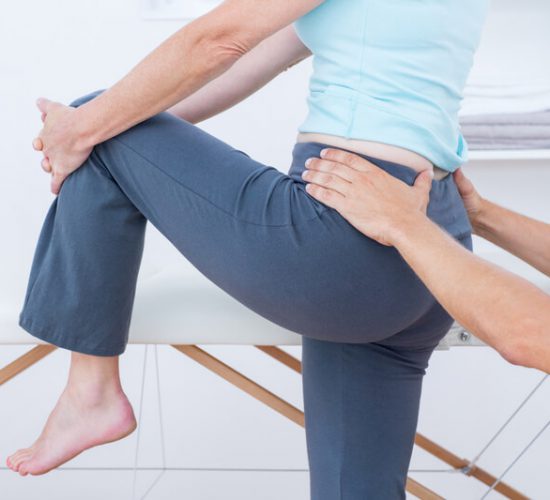 Physiotherapist examining his patient back